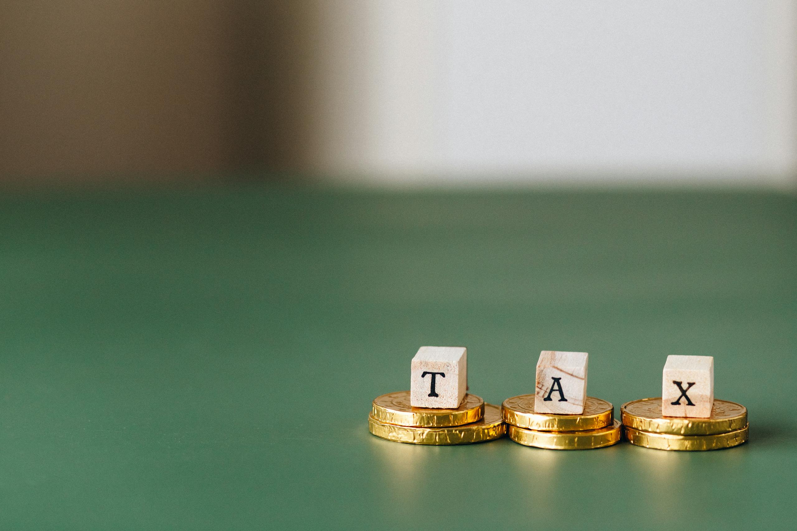 Tax Word on Top of Gold Coins